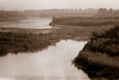 Wide river flowing through flat country